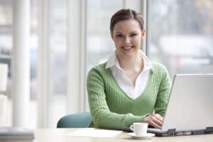 portrait-of-young-businesswoman-sitting-at-desk-1